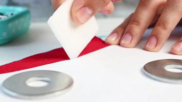 Designer marks red fabrics with chalk for making clothes. Sewinf patterns video