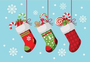 Set Of New Year's Socks In Christmas Style. Red Shoe With Lollipops, Gift. Green Sock With Christmas Gingerbread And Box. Red Checkered Sock With A Surprise. Beautiful Blue Background With Snowflakes vector