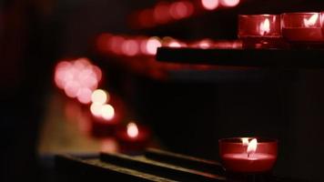 Rote Wunsch- und Gebetskerzen in einer katholischen Kirche video