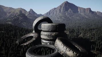 Abandoned car tires in mountains photo