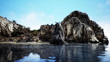 Galapagos volcanic rock formation in ocean photo