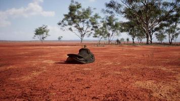 Old decorated mexican saddle lying on sand photo