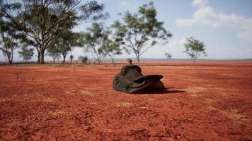 Old decorated mexican saddle lying on sand photo