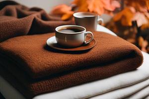 a book sitting on top of a bed next to a cup of coffee photo