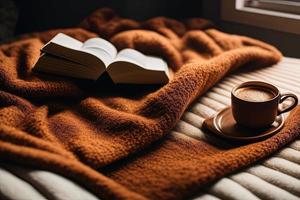 a book sitting on top of a bed next to a cup of coffee photo