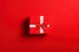 photo of a gift box with a red bow and hearts on a red background