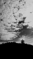 black-white picture vertically, dark sky white cloud above top view high mountain, landscape background around countryside. Thailland photo