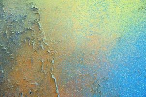 A large fragment of the graffiti pattern applied to the wall with aerosol paint. The gradient between several colors is carried out by spraying the paint. Abstract background image photo