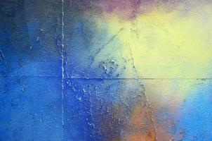 A large fragment of the graffiti pattern applied to the wall with aerosol paint. The gradient between several colors is carried out by spraying the paint. Abstract background image photo