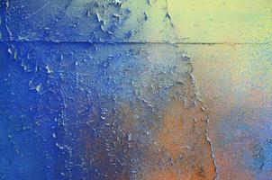 A large fragment of the graffiti pattern applied to the wall with aerosol paint. The gradient between several colors is carried out by spraying the paint. Abstract background image photo