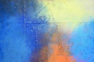 A large fragment of the graffiti pattern applied to the wall with aerosol paint. The gradient between several colors is carried out by spraying the paint. Abstract background image photo