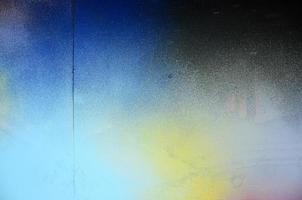 A large fragment of the graffiti pattern applied to the wall with aerosol paint. The gradient between several colors is carried out by spraying the paint. Abstract background image photo