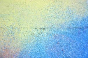 A large fragment of the graffiti pattern applied to the wall with aerosol paint. The gradient between several colors is carried out by spraying the paint. Abstract background image photo