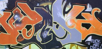 Street art. Abstract background image of a full completed graffiti painting in dark grey and red tones photo