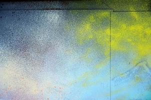 A large fragment of the graffiti pattern applied to the wall with aerosol paint. The gradient between several colors is carried out by spraying the paint. Abstract background image photo