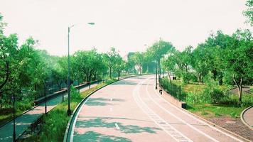 Empty asphalt road in city with trees photo