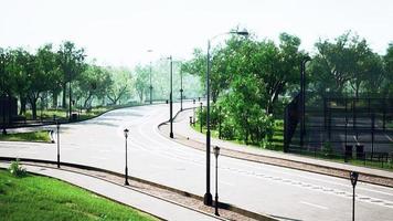 Empty asphalt road in city with trees photo