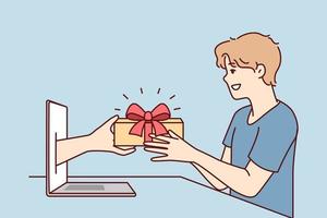 Young man receives present from hand poking out of laptop screen after shopping in online store. Metaphor of gift for buying computer or in marketing campaign with cashback reward. Flat vector image