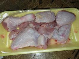 Cooking chopped chicken with an ax in a pan photo