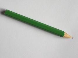 green pencil on paper sheet desk photo