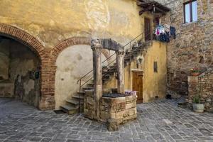 san quirico medieval houses with water well photo