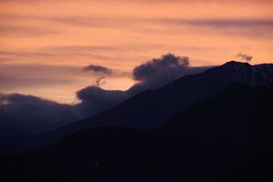 View of valley around Bismantova stone a rock formation in the Tuscan-Emilian Apennines at sunset photo