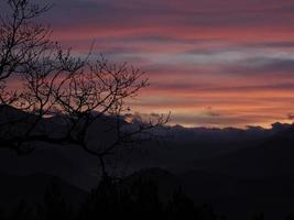 View of valley around Bismantova stone a rock formation in the Tuscan-Emilian Apennines at sunset photo