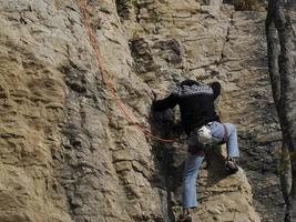 Rock Climber climbs on the Bismantova Stone in the Tosco Emiliano Appennino Park photo