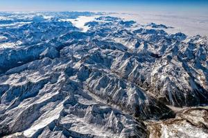 Alps mountains aerial view from airplane snow and avalanches photo