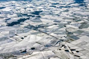 farmed fields covered by snow aerial panorama photo