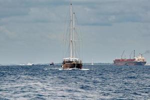 maldivian sailship boat in blue ocean photo