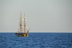 Old vessel sail ship in open sea photo