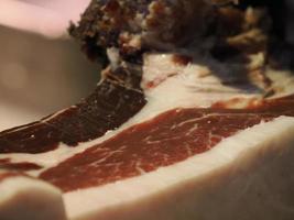 cutting spanish iberic cured ham photo