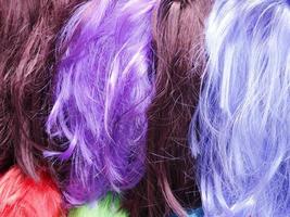 Colorful wig accessories. Sales at the market. Different wigs for women. photo