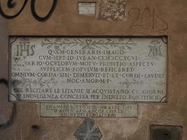 Medieval inscription on marble imperial forums fori imperiali rome buildings on walkway photo