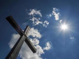 wooden cross on blue sky background photo