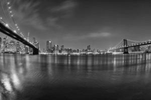 vista nocturna del puente de manhattan de nueva york desde brooklyn foto