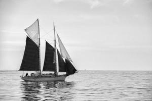 boat sailing in black and white photo