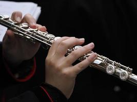 hands playing flute detail photo