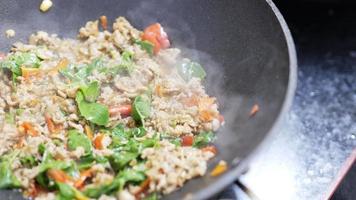Cooking stir fried chicken with basil