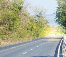 paved road speed  green forest travel holiday tourism  use of road safety photo