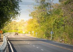 paved road speed  green forest travel holiday tourism  use of road safety photo