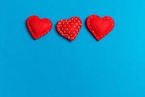 Top view of textile hearts on colorful background. Valentine's day concept with copy space photo