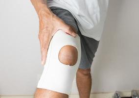 Man wearing an elastic type ace bandage on his knee photo