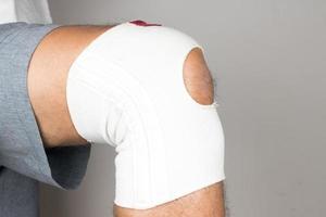 Man wearing an elastic type ace bandage on his knee photo