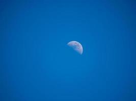 half moon in the blue sky photo