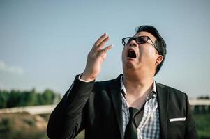 Businessman Yawning while Standing Outdoor photo