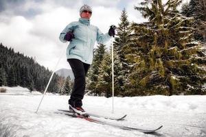 Active senior. Cross-country skiing. Winter sport activities photo