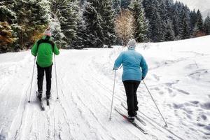 Active seniors. Cross-country skiing. Winter sport activities photo