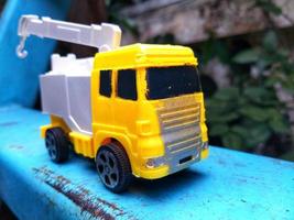 yellow truck toy car on the blue surface. children toys fun time. photo